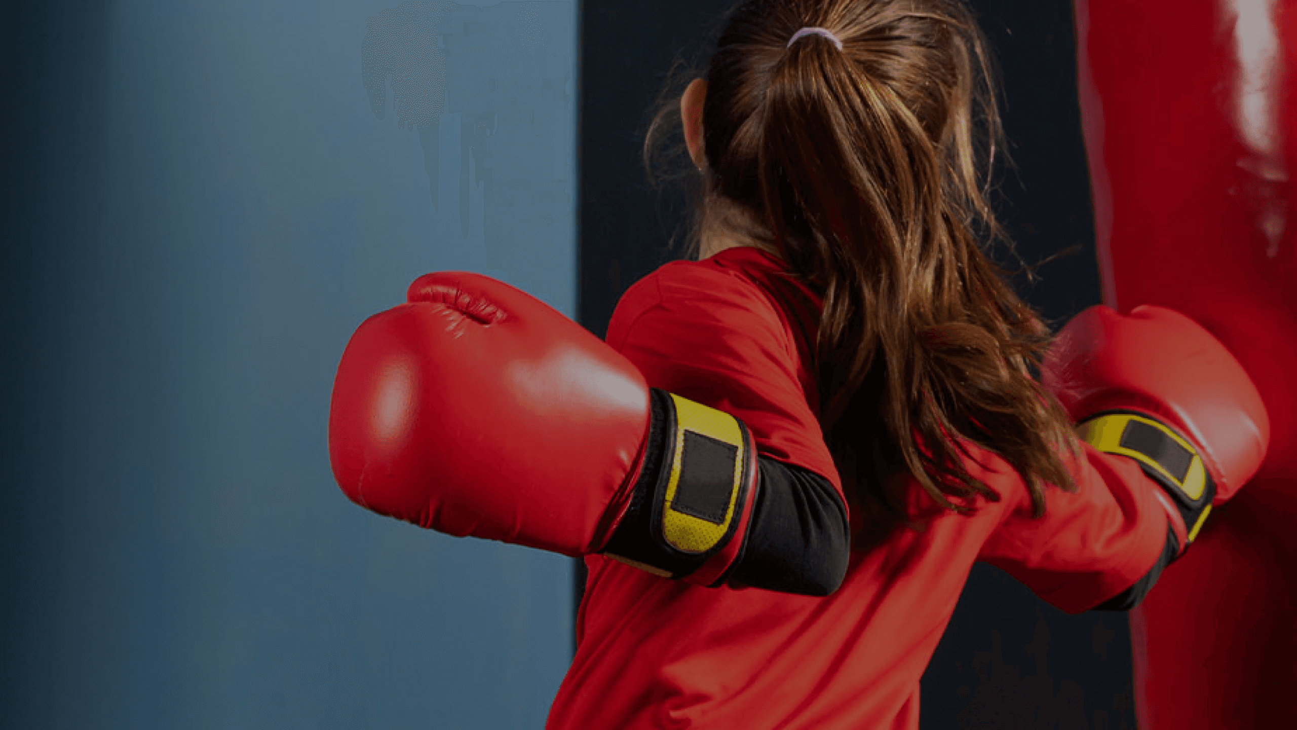 Young person training with boxing gloves and a punching bag